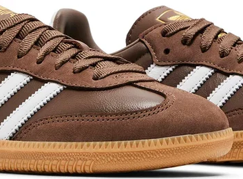 Brown shoes with white stripes on a white background
